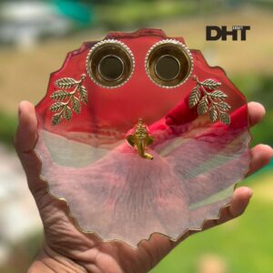 Pooja thali in hand red color and with golden leaf and ganpatiji idol