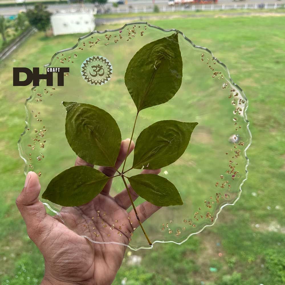 Custom preserved billipatra in resin made from customer’s sacred bilva leaf with golden flakes and Om symbol